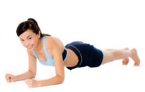 A young attractive Asian woman doing a plank pose